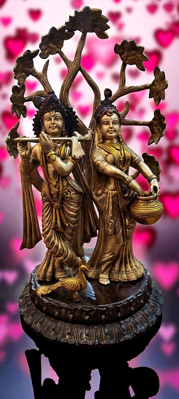 Handcrafted brass Radha Krishna sculpture beneath a tree, a statement focal piece